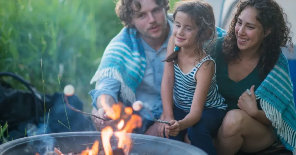 Kids roasting marshmallows over a campfire during a fun family camping night